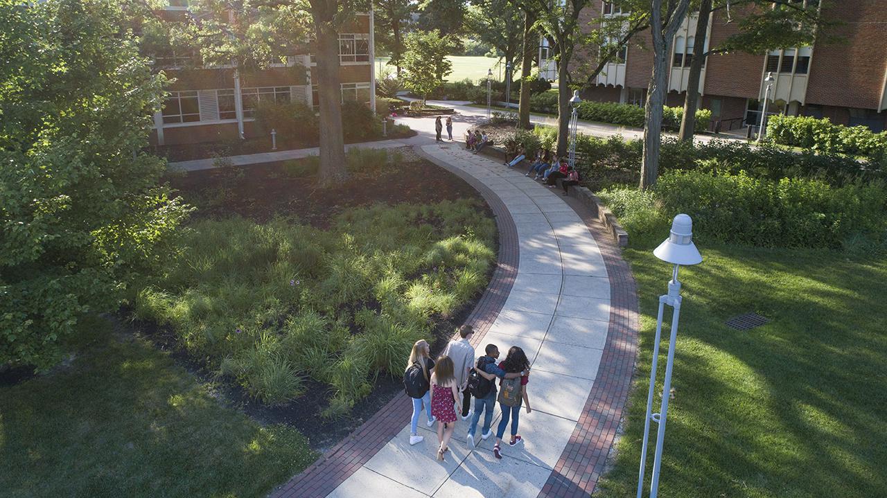 A group of students walking across campus