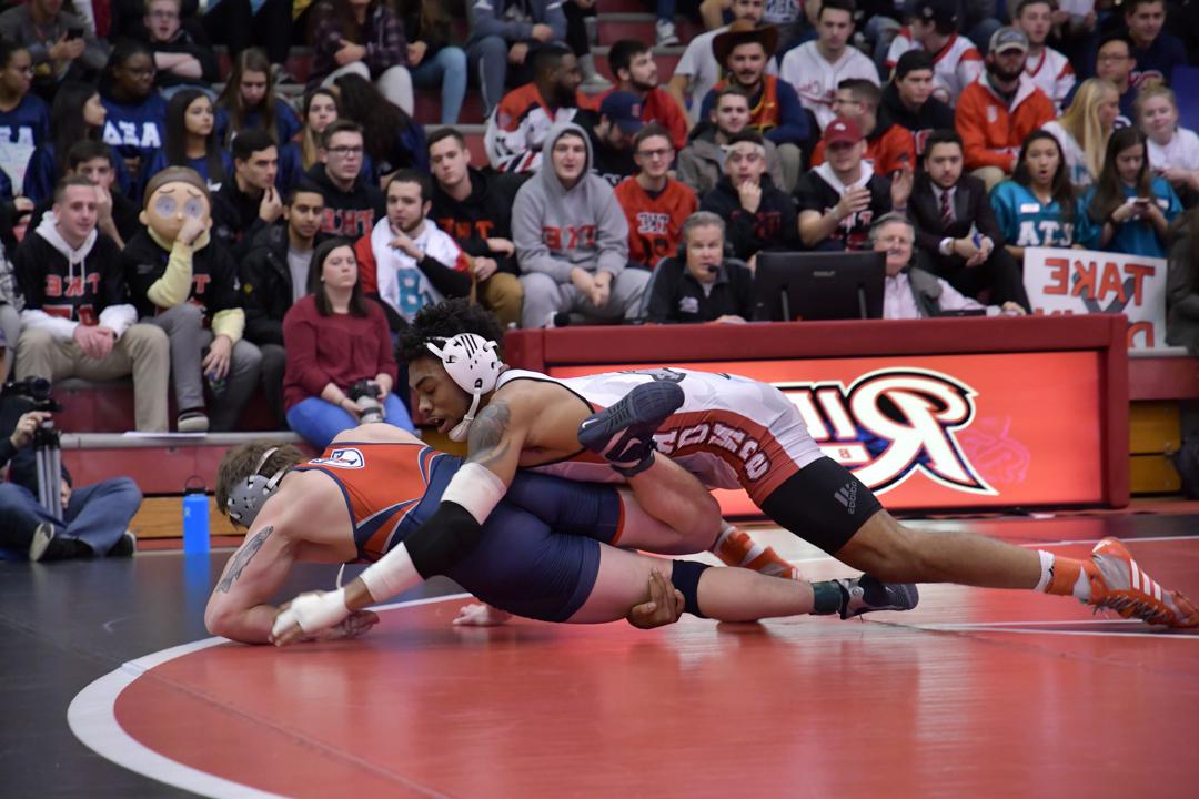 Wrestlers wrestle at Rider game.