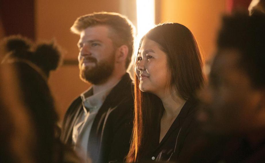 Students smile while listening to lecture